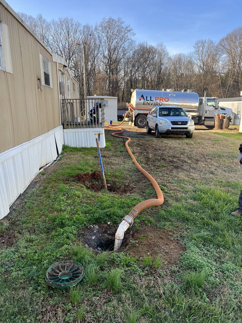 All Pro Enviro technician performing septic tank pumping service